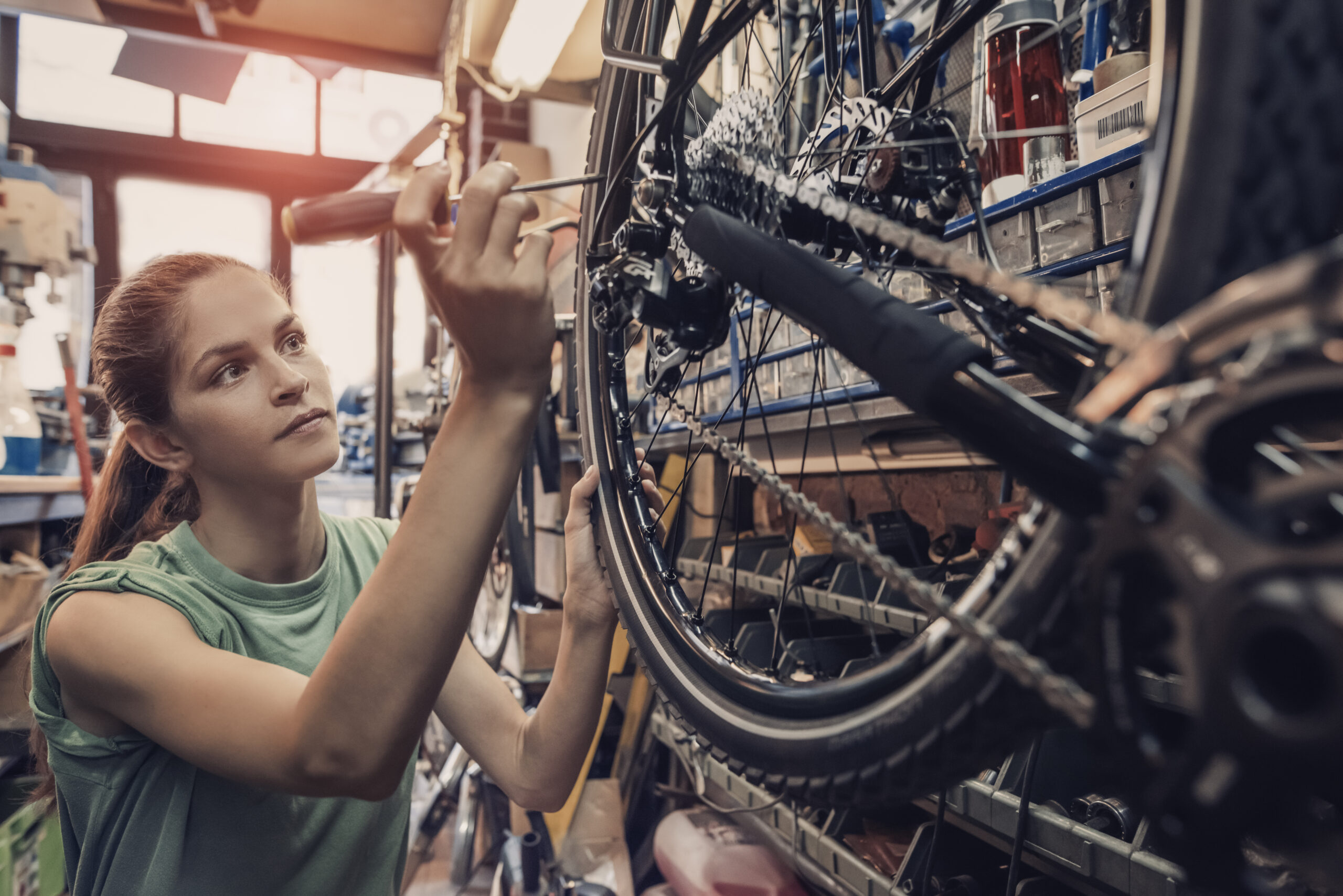 Woman,Bicycle,Mechanic,Is,Repairing,A,Bike,In,The,Workshop Woman,Bicycle,Mechanic,Is,Repairing,A,Bike,In,The,Workshop